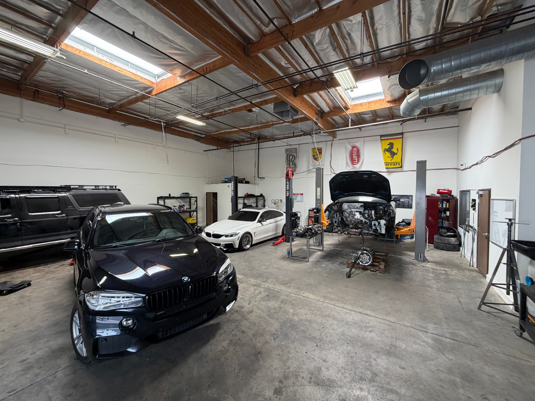 Inside the RPM Motors shop floor in Las Vegas with vehicles staged for service